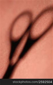 Close-up of the shadow of a pair of scissors