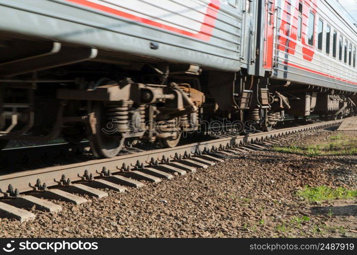 close - up of the train wheel on the railway. passenger train on the railway