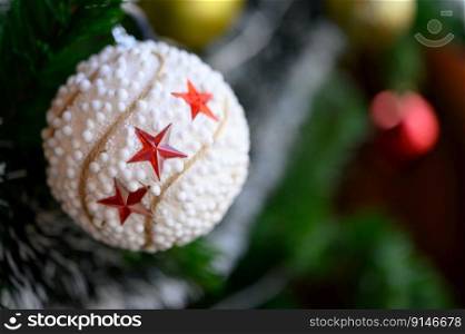 Close-up of the white ball hanging from the Christmas tree.