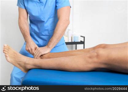 Close-up of therapist massaging young man&rsquo;s foot. High quality photo.. Close-up of therapist massaging young man&rsquo;s foot