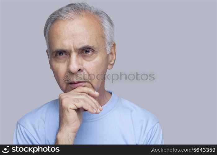 Close-up of thoughtful man over gray background