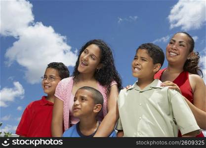 Close-up of three boys and two teenage girls smiling