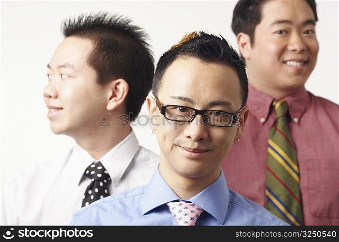 Close-up of three businessmen smiling