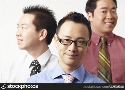 Close-up of three businessmen smiling