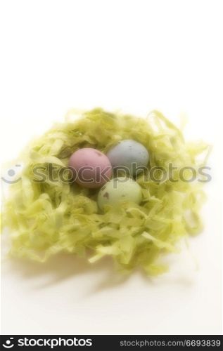 Close-up of three Easter eggs in a nest
