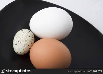 Close-up of three eggs in a plate