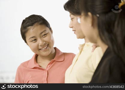 Close-up of three female office workers smiling