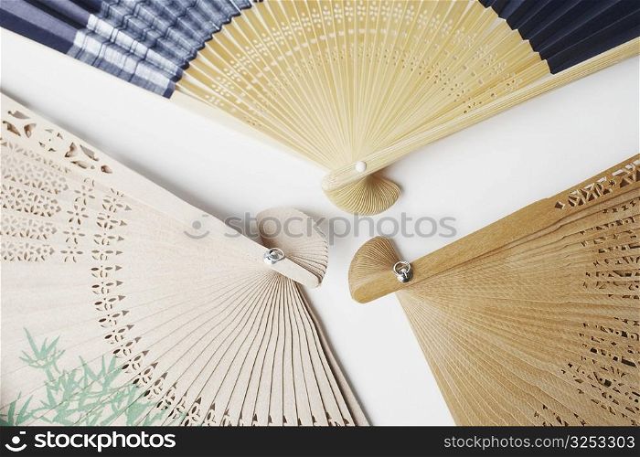 Close-up of three folding fans
