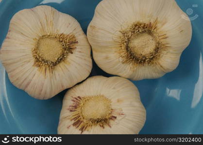 Close-up of three garlic in a bowl