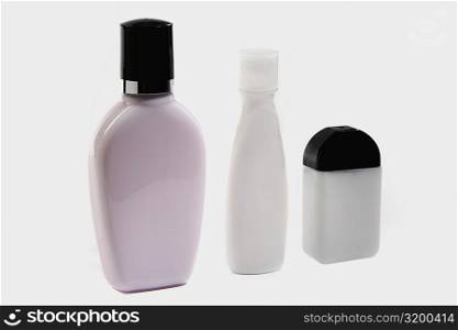 Close-up of three moisturizer bottles