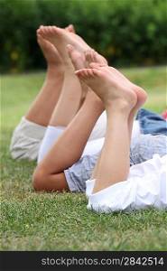 Close-up of three peoples legs in park