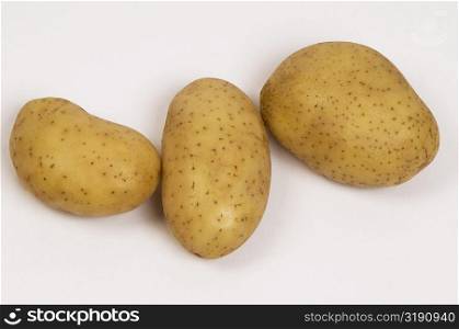 Close-up of three raw potatoes