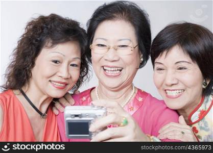 Close-up of three senior women taking a photograph of themselves