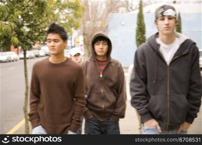 Close-up of three teenage boys walking