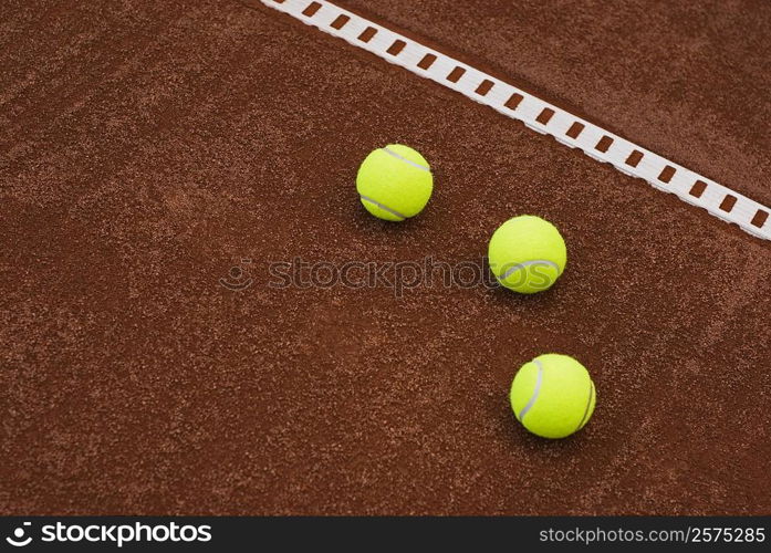 Close-up of three tennis balls in a court