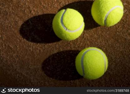 Close-up of three tennis balls in a court