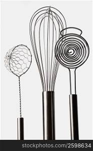 Close-up of three wire whisks