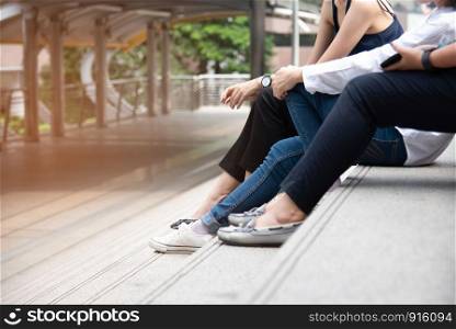 Close up of three woman legs. Friend talking together on stair together. People and lifestyles concept. Social and Conversation concept. Friendship theme.