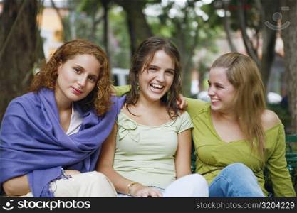 Close-up of three young women sitting together