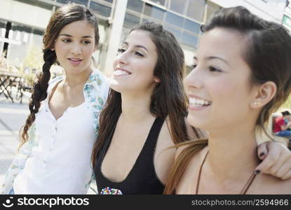 Close-up of three young women smiling