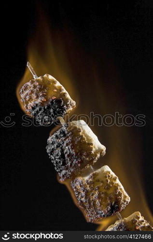 Close-up of toasted marshmallows on a skewer
