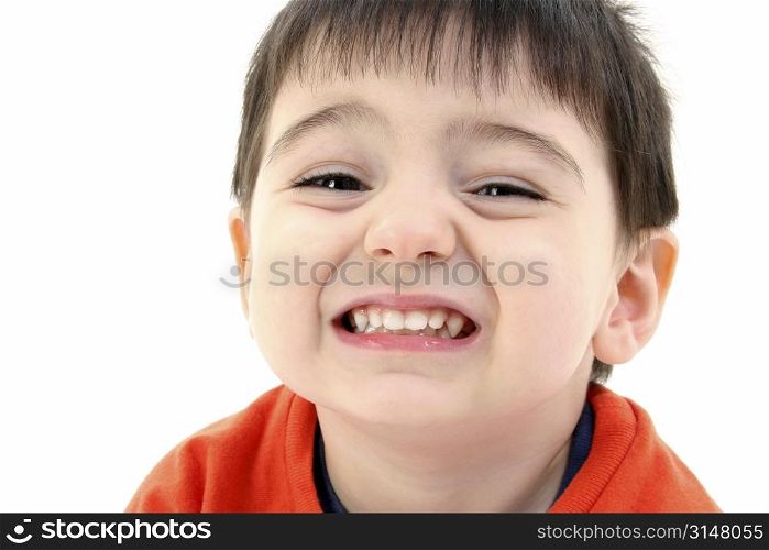 Close up of toddler boy smiling. Wearing orange casual shirt.