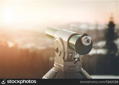 Close up of tourist binocular in Austria, wintertime and sundown