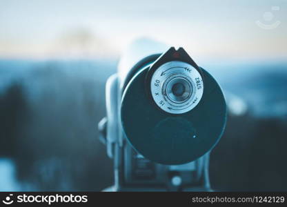 Close up of tourist binocular in Austria, wintertime and sundown