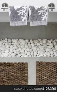 Close-up of towels and pebbles in the bathroom