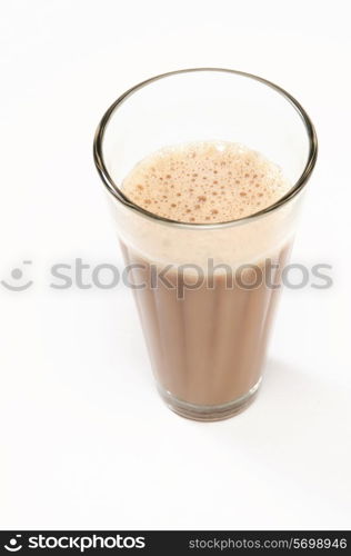Close-up of traditional Indian milk tea isolated over white background