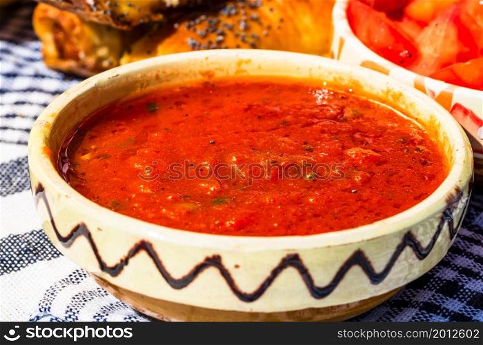 Close up of traditional rustic bowl with homemade tomatoes sauce.