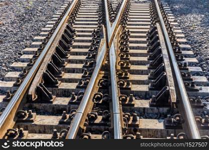 Close up of train or railroad tracks with cement backing In the countryside Thailand