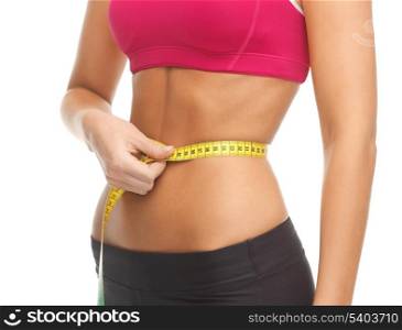 close up of trained belly with measuring tape