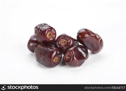 Close-up of tropical date fruits isolated over white background.