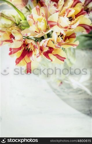 Close up of tulips bunch in grass vase, top view