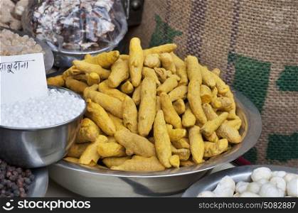Close-up of Turmeric root and sabudana for sale at the shop