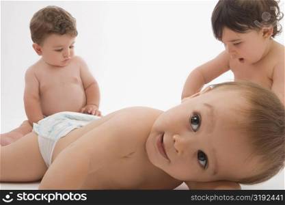 Close-up of two baby boys with a girl