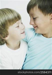 Close-up of two boys looking at each other