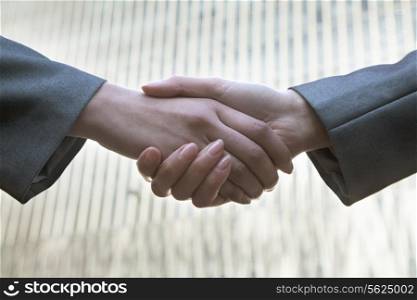 Close up of two business people shaking hands by Chinas world trade center in Beijing