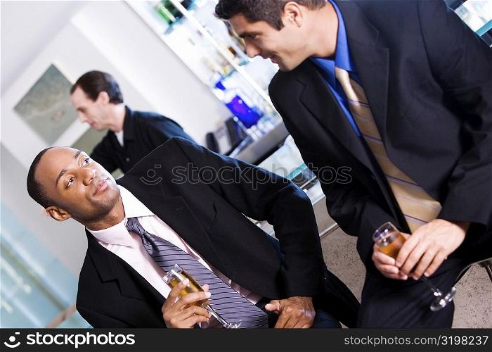 Close-up of two businessmen holding champagne flutes