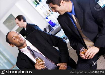 Close-up of two businessmen holding champagne flutes