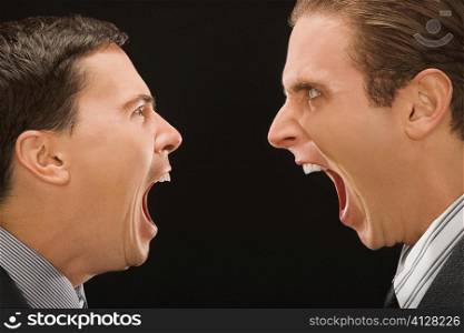 Close-up of two businessmen shouting at each other
