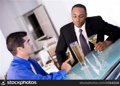 Close-up of two businessmen sitting in a bar