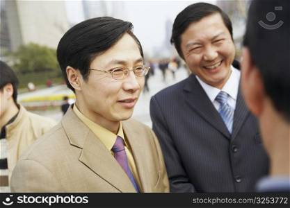 Close-up of two businessmen smiling