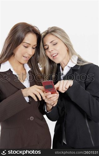 Close-up of two businesswomen looking at a mobile phone