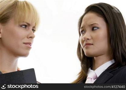 Close-up of two businesswomen looking at each other