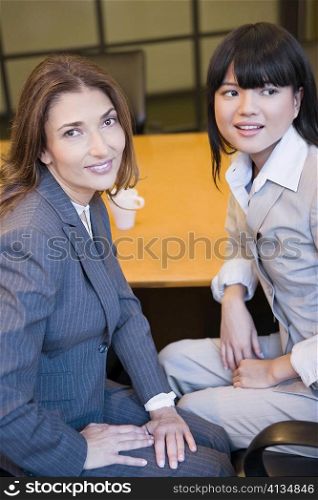 Close-up of two businesswomen smiling