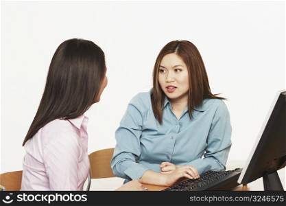 Close-up of two businesswomen talking