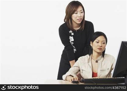 Close-up of two businesswomen using a computer