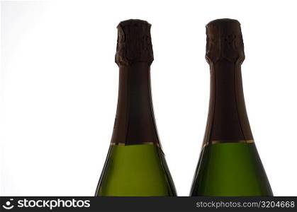 Close-up of two champagne bottles
